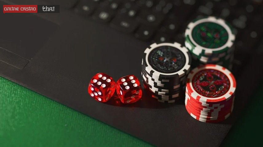 dice-and-poker-chips-on-a-laptop